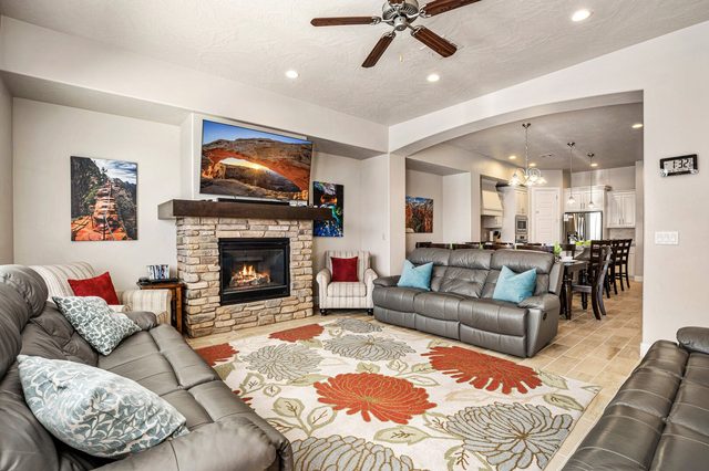 Leather sofas around the stone gas fireplace and TV