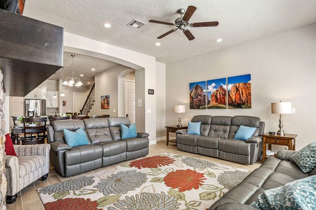 Living room leather sofas with the kitchen and dining area behind