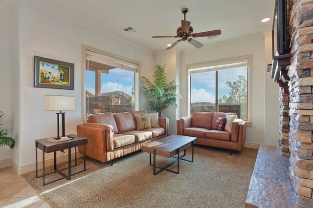 Living room with two leather sofas and large windows