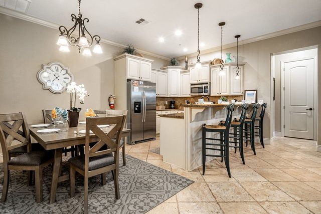 Dining table for six beside the kitchen island at Coral Springs B6