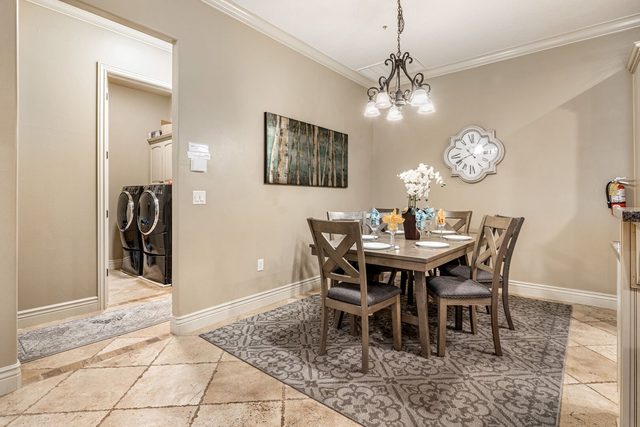 Dining area with chandelier and view of the laundry nook