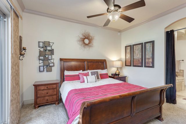 Master bedroom with king sleigh bed and pink bedding
