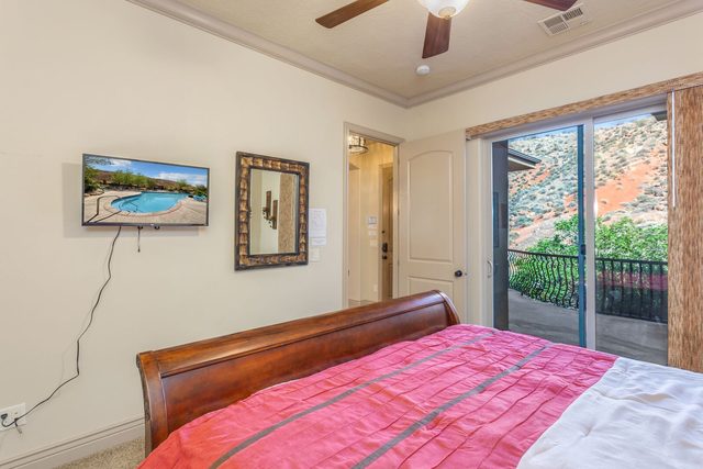 Master bedroom king bed with TV and balcony slider