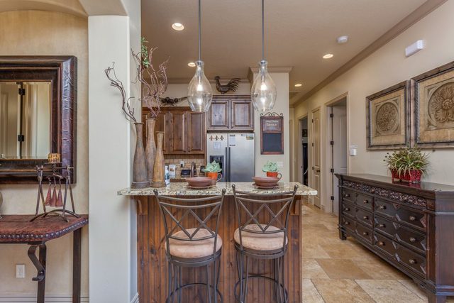 Kitchen breakfast bar with two stools and pendant lights