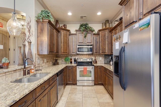 Kitchen with alder cabinets, granite counters and stainless appliances
