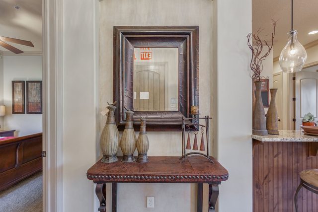 Entry hall with carved console table and framed mirror
