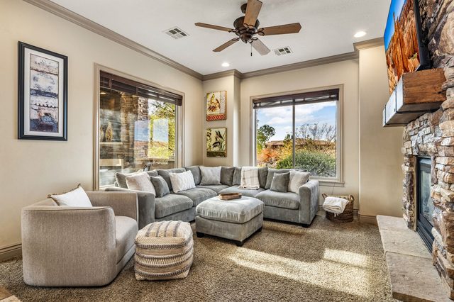 Living room sectional and stone fireplace at Coral Springs D7