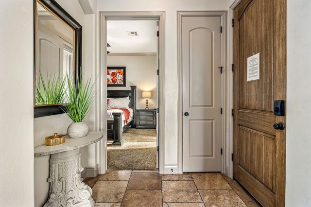Entry foyer with keypad door and view into the king bedroom