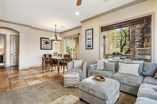 Living room seating with patio window and dining area beyond