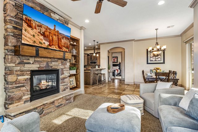 Stone fireplace wall with TV, sectional and dining nook