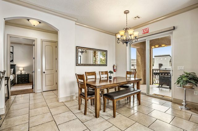 Dining table with bench seating beside patio doors