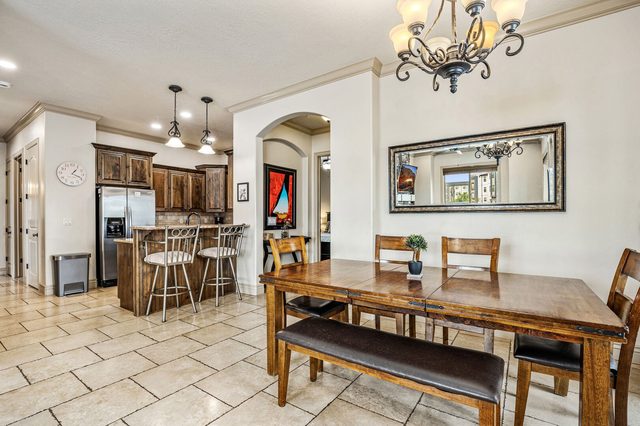 Dining table with kitchen breakfast bar in background