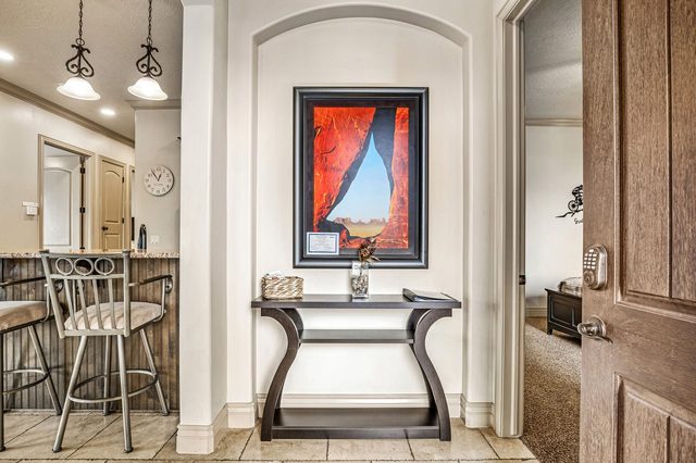 Entry hall with console table, artwork and kitchen bar stools