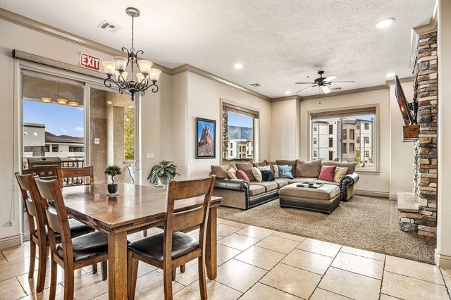 Open living and dining area with sectional and large windows