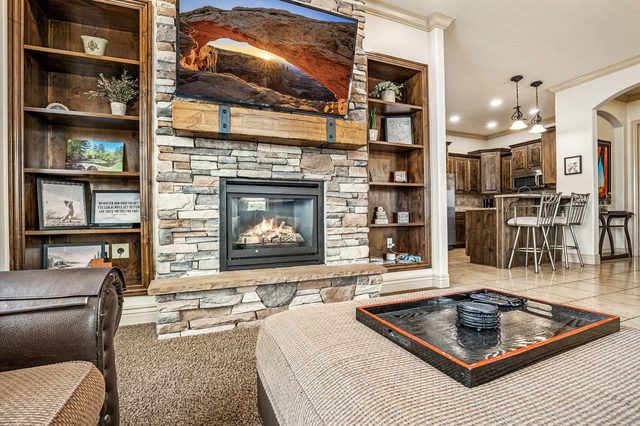 Stone fireplace with mounted TV and built-in shelving
