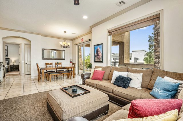 Living room sectional with dining table and patio door beyond