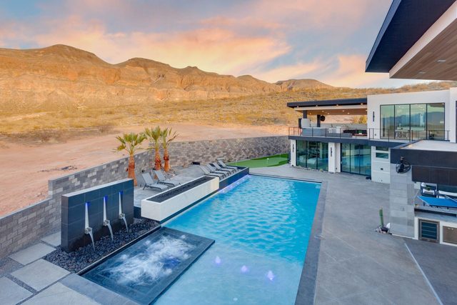 Private pool with water feature spa and desert hills at sunset
