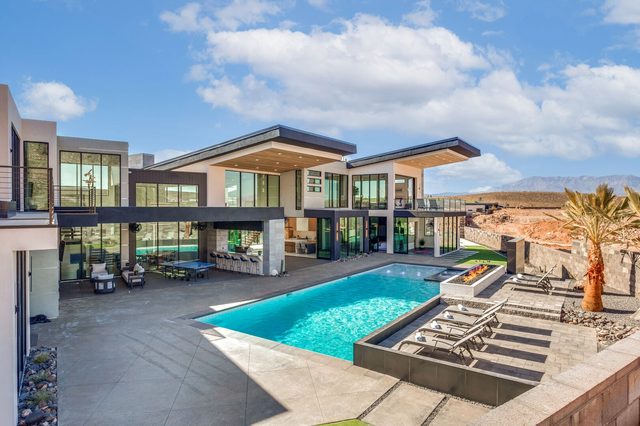 Aerial of the private pool, backyard and rear of the home