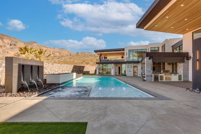 Private pool with spa fountains and view toward the house