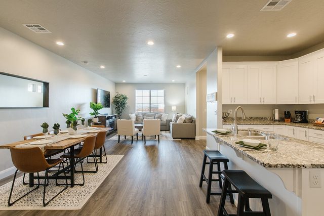 Open main floor with dining table, kitchen bar and living area
