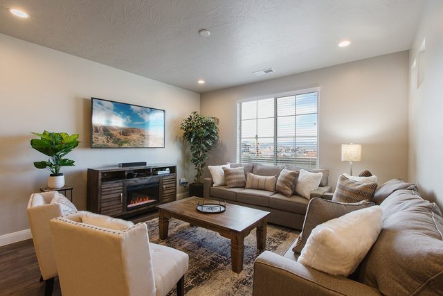 Living room sofas, electric fireplace and wall-mounted TV