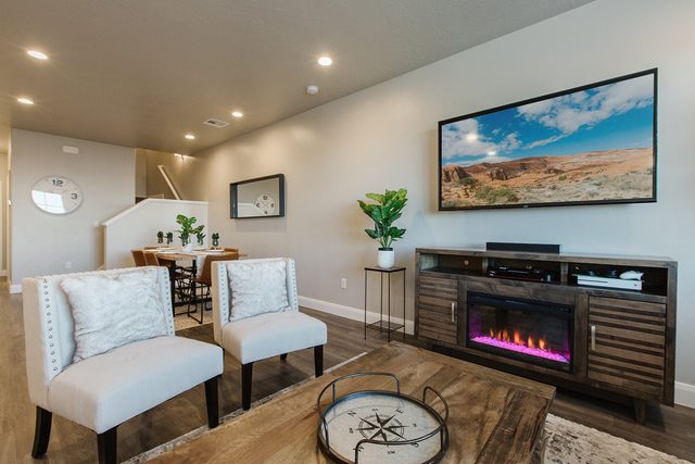 Accent chairs facing the electric fireplace and TV