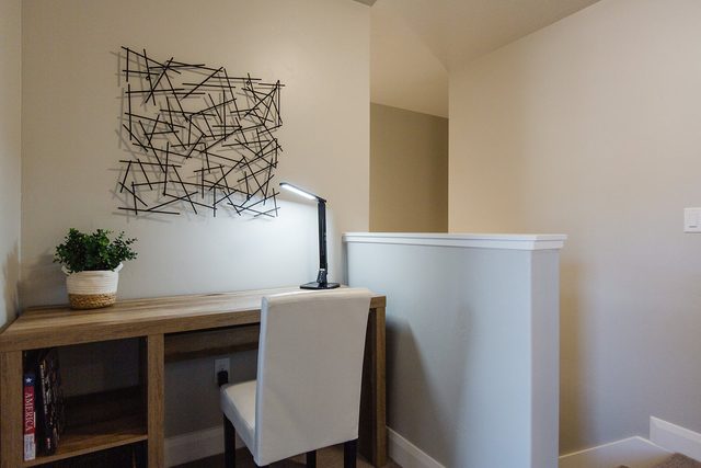 Upstairs workspace desk with lamp and chair