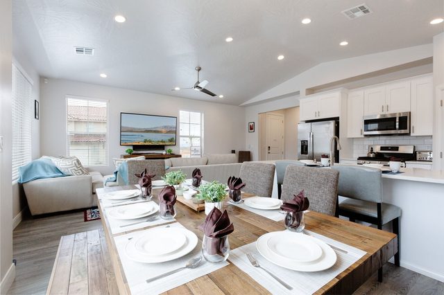 Farmhouse dining table set for eight beside the open kitchen