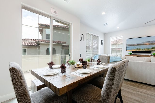 Dining table with patio slider and living room beyond at Escondido 1126
