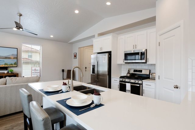 Kitchen island with bar seating, stainless fridge and gas range