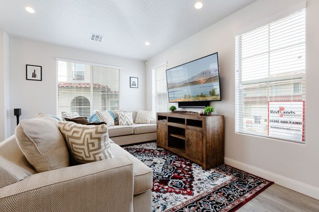 Living room with sectional sofa, wall TV and patterned rug at Escondido 1126