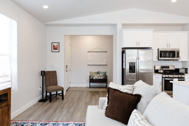 Entry hallway with bench and view into the kitchen