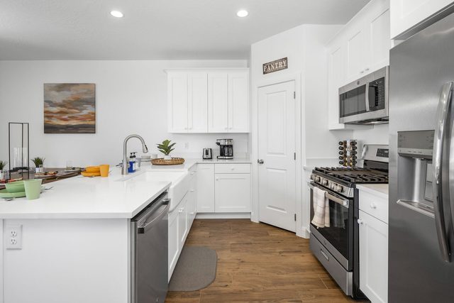 Kitchen with gas range, pantry and white cabinets at Escondido 1145