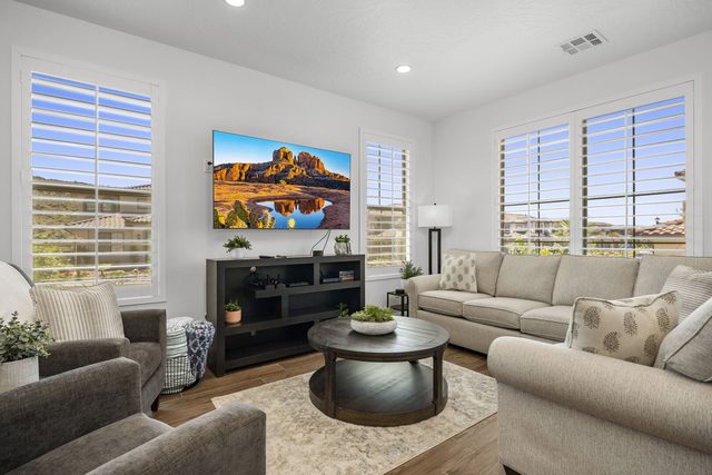 Living room with sectional sofa and wall-mounted TV at Escondido 1145