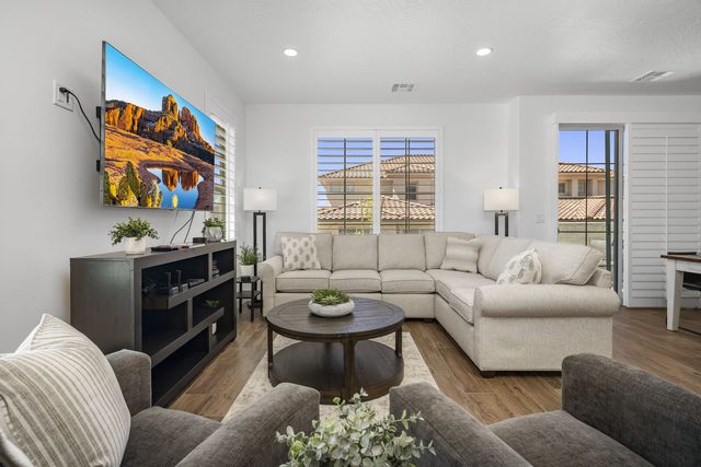 Living room with sectional sofa, TV and patio door at Escondido 1145