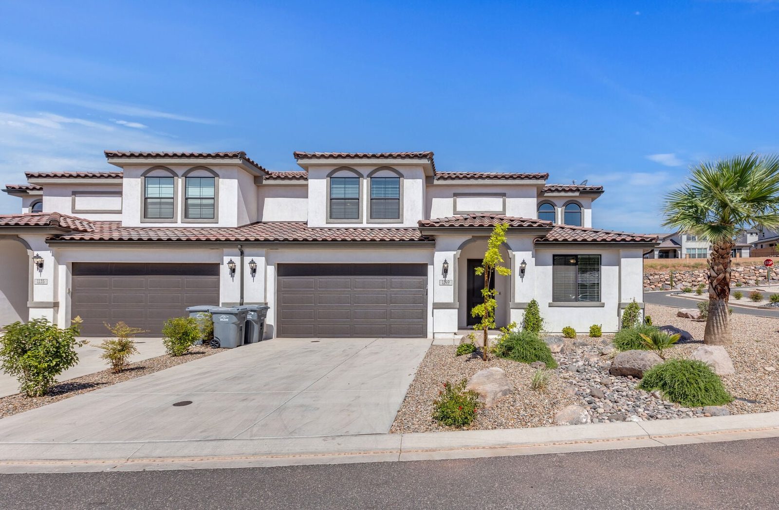 Front of Escondido 1149 with two-car garage and palm tree