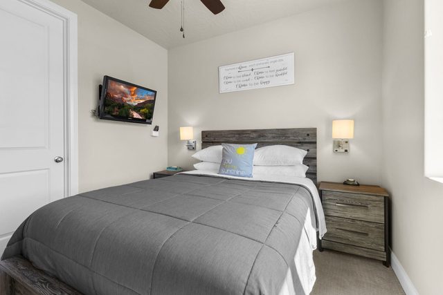 Downstairs queen bedroom with rustic headboard and nightstand