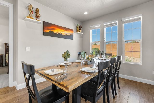 Dining table for eight beside a bank of windows