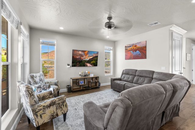 Main floor living room with sectional sofa and TV at Escondido 1149