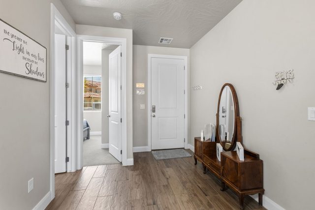 Entry hallway with antique dresser and oval mirror