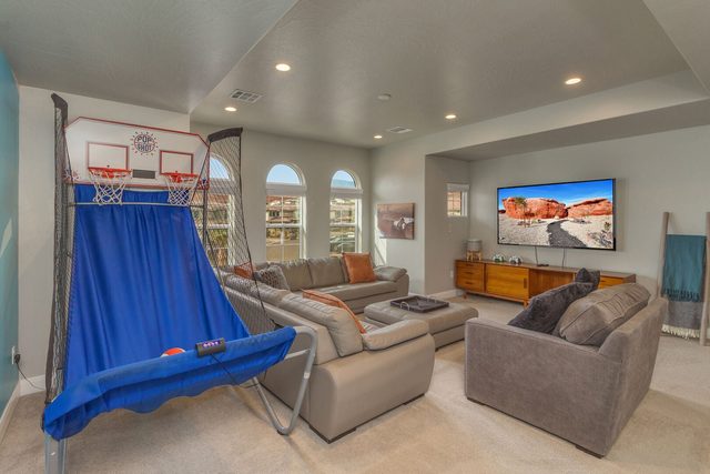 Loft lounge with sectional, TV and basketball arcade game