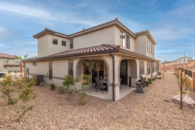 Rear of Escondido 2275 with covered patio and desert landscaping