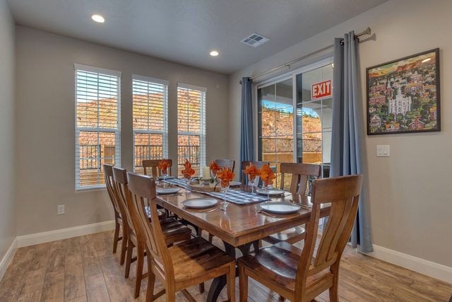 Wood dining table set for eight near the patio door