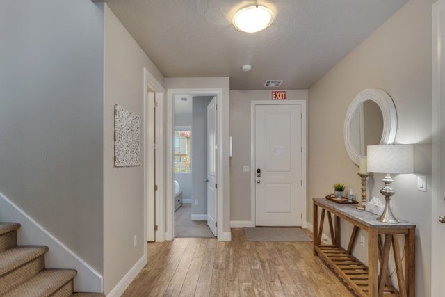 Entry hallway with console table and stairs to the upper level