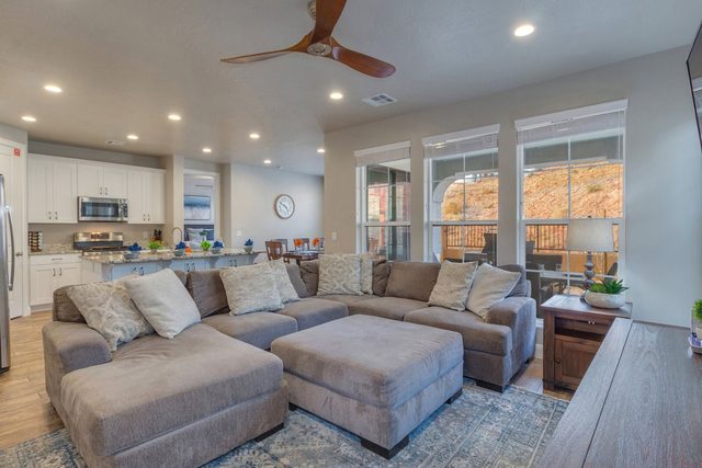 Great room sectional and ottoman open to the kitchen
