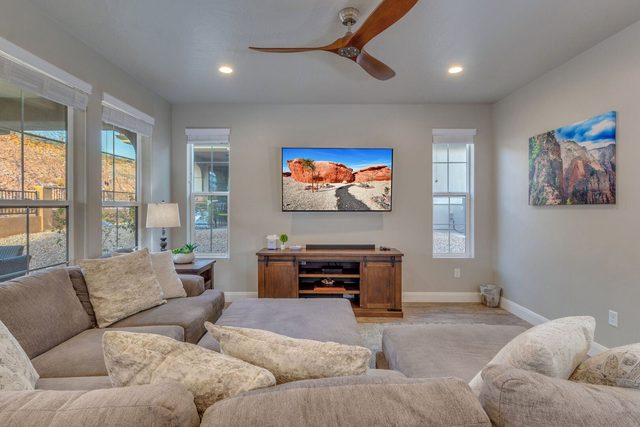 Great room with oversized sectional facing a wall-mounted TV