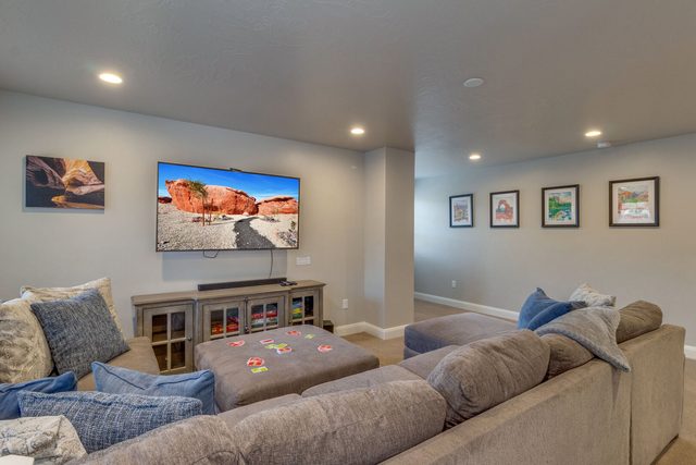 Upstairs loft with large sectional, ottoman and flat-screen TV