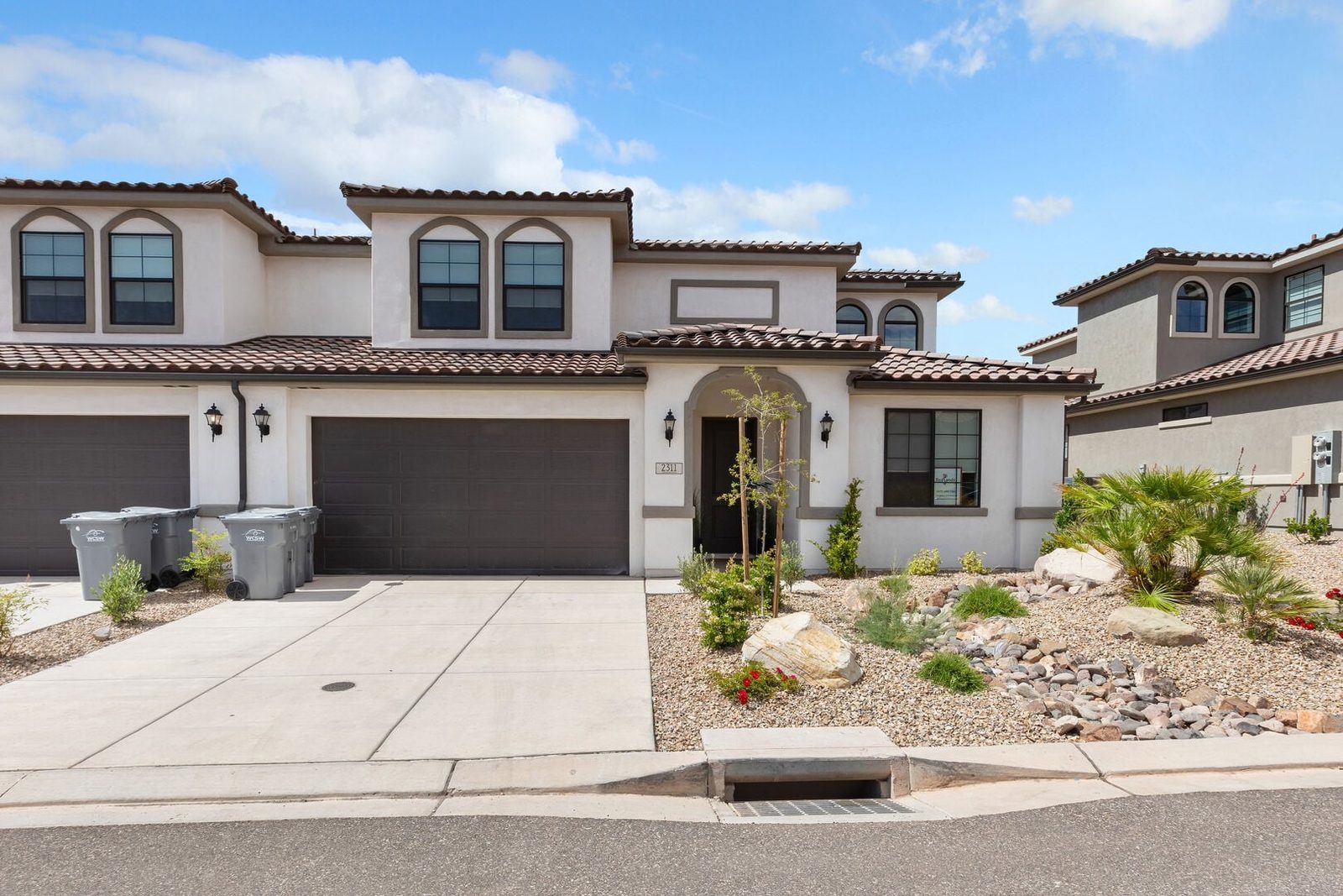 Front exterior of Escondido 2311 with two garages and desert landscaping