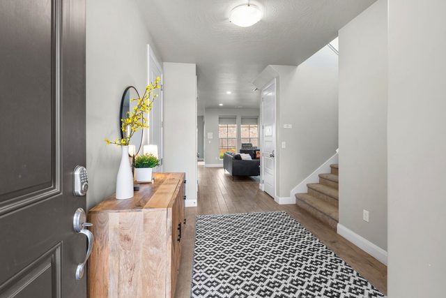 Front entry with wood console and staircase to the loft
