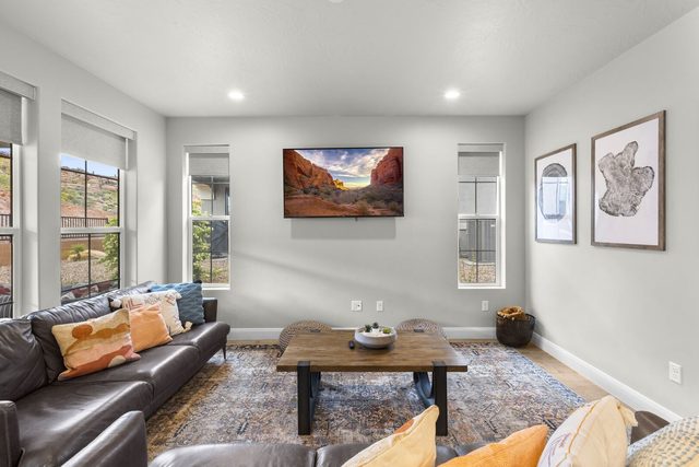 Living room with leather sofas, wood coffee table and TV